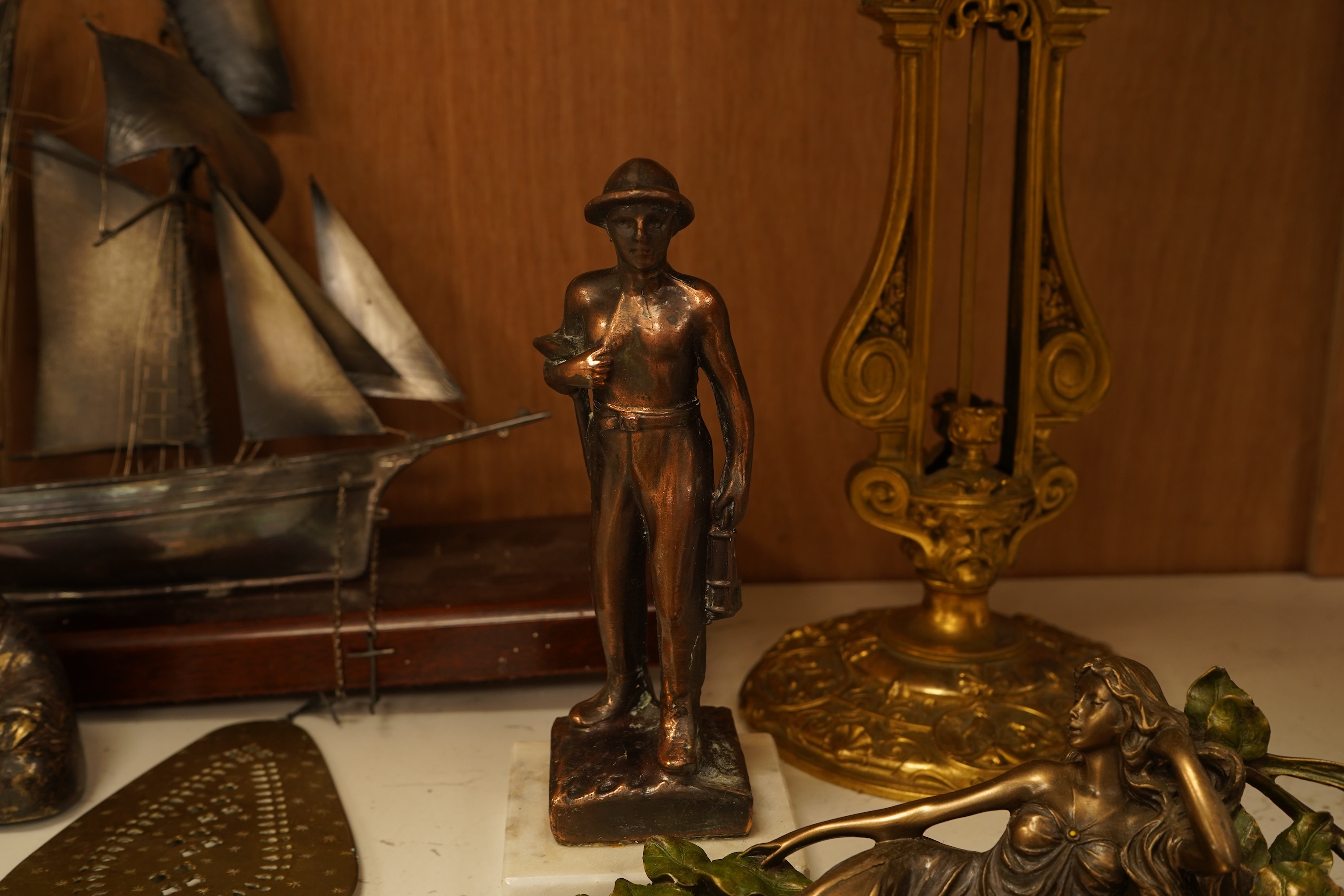 A mixed group of metalware including an Art Nouveau figural dish and pewter dish, a candlestick etc